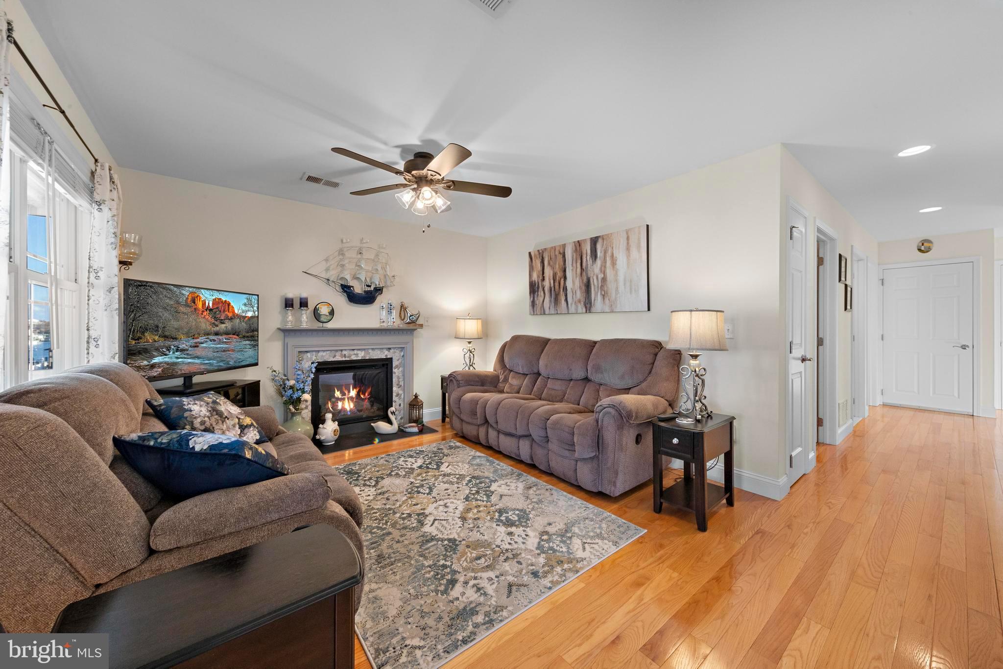 32 West Navasink Drive Little Egg Harbor, NJ 08087 - Photo 16 of 71 a living room with furniture a fireplace and a large window