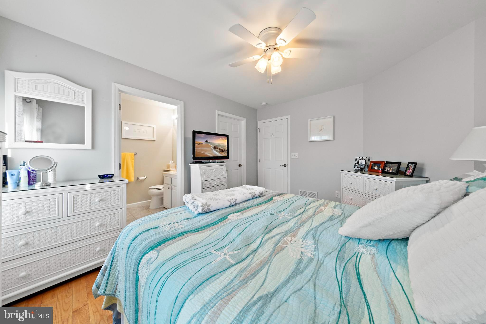 32 West Navasink Drive Little Egg Harbor, NJ 08087 - Photo 36 of 71 a bedroom with a bed and a chandelier