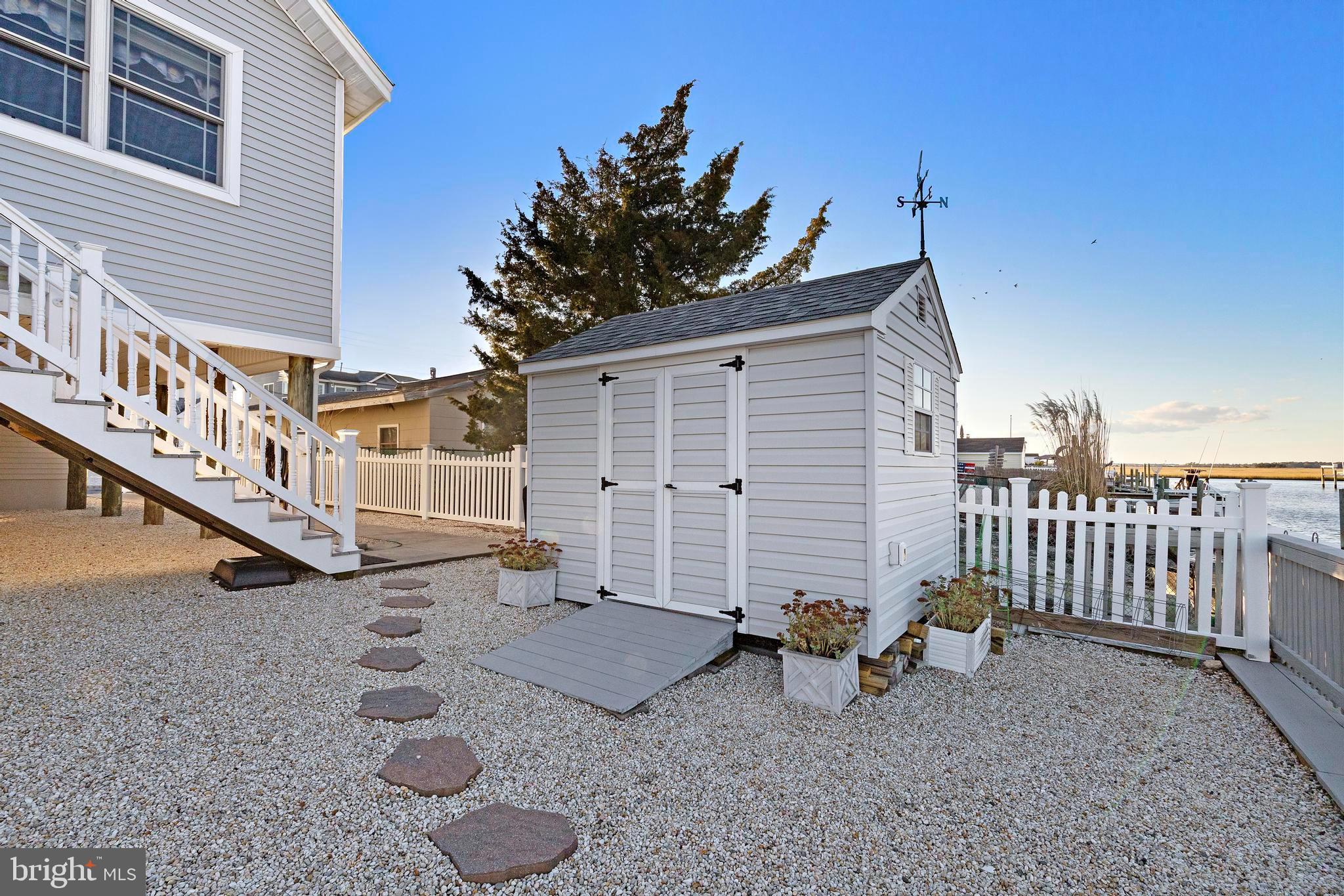 32 West Navasink Drive Little Egg Harbor, NJ 08087 - Photo 56 of 71 a view of a house with a yard and wooden fence