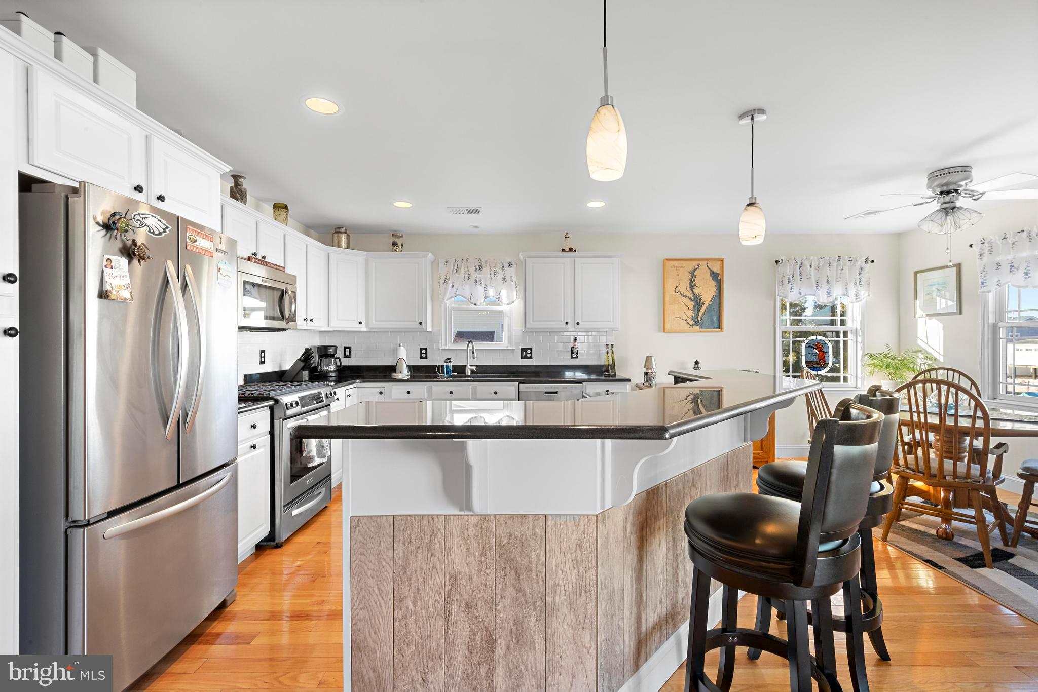 32 West Navasink Drive Little Egg Harbor, NJ 08087 - Photo 8 of 71 a kitchen with stainless steel appliances granite countertop a dining table chairs refrigerator and microwave
