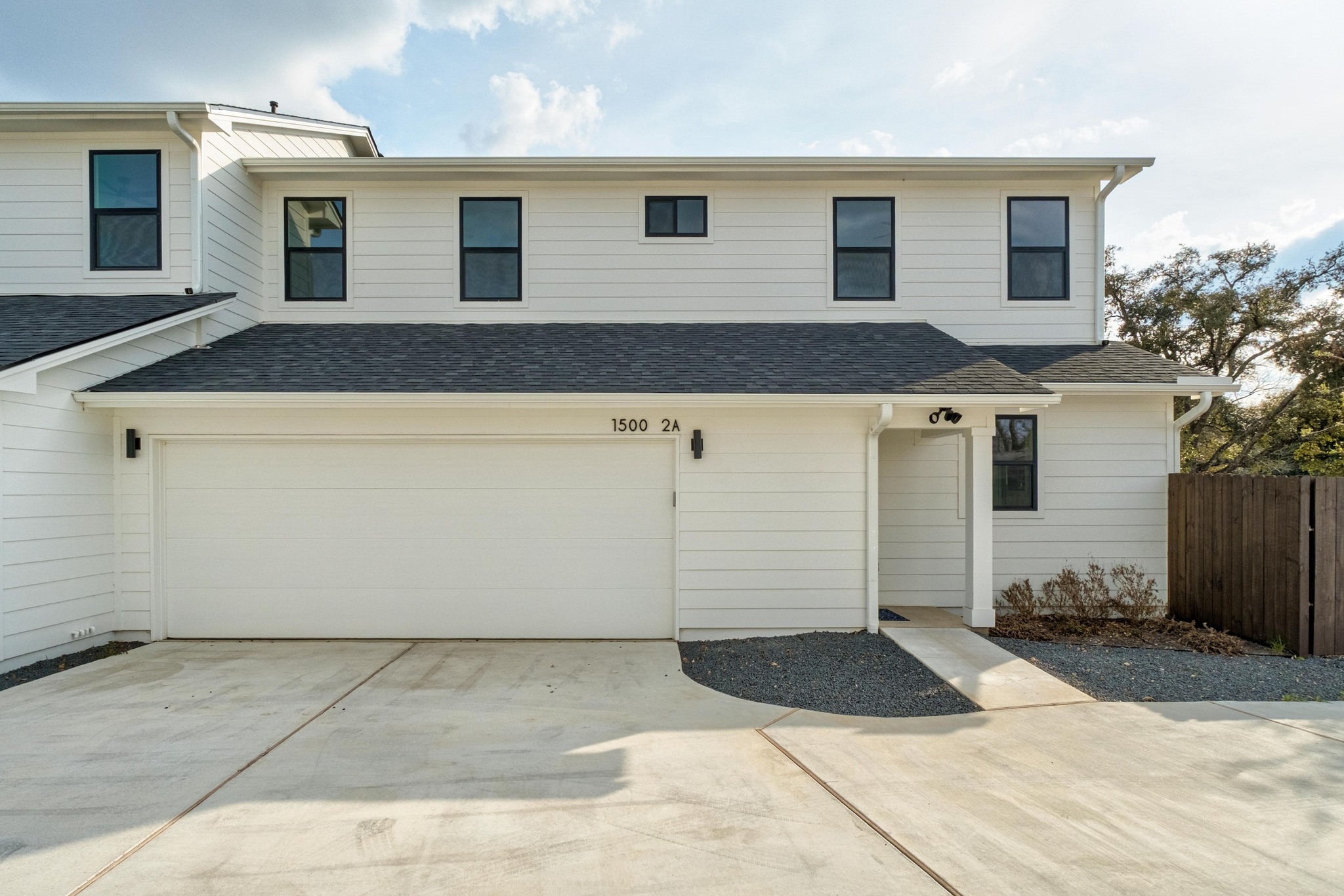 a front view of a house with garage