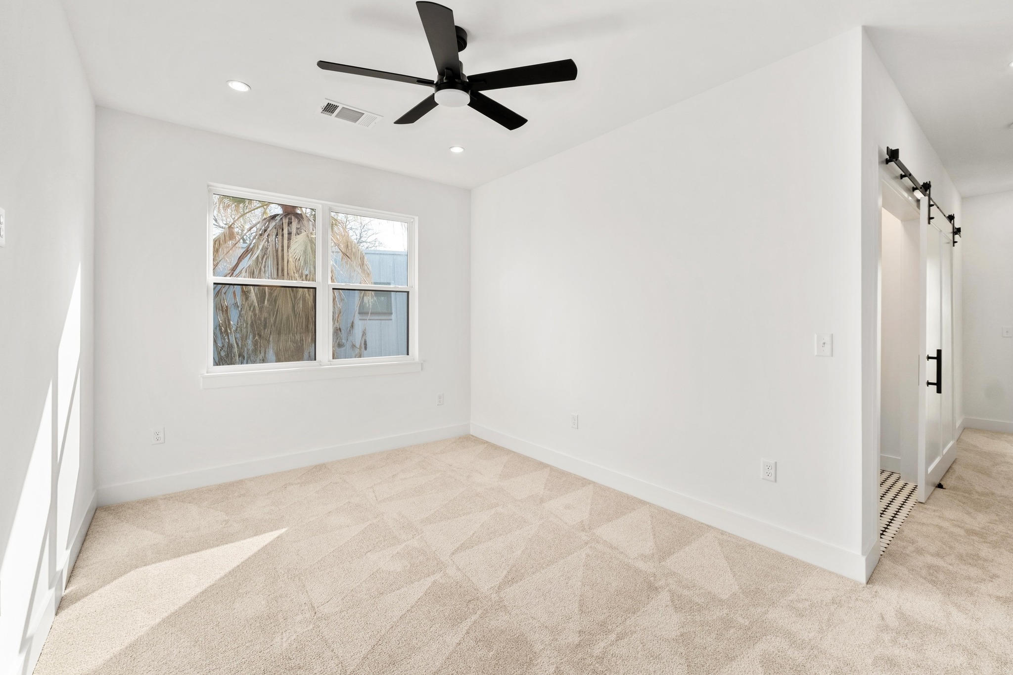 1500 Sylvan Glade, Unit 2A Austin, TX 78745 - Photo 18 of 29 an empty room with a window and a fan