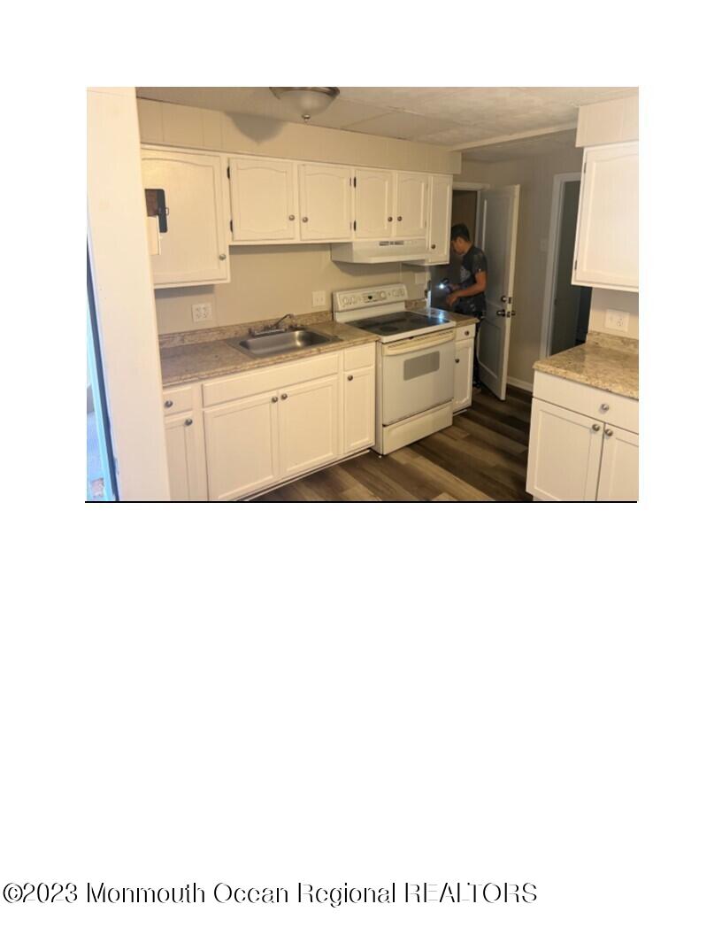 105-107 Atlantic Street Bridgeton, NJ 08302 - Photo 13 of 20 a living room with stainless steel appliances kitchen island granite countertop a sink and cabinets