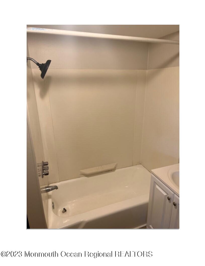 105-107 Atlantic Street Bridgeton, NJ 08302 - Photo 15 of 20 a bathroom with a tub shower and a sink