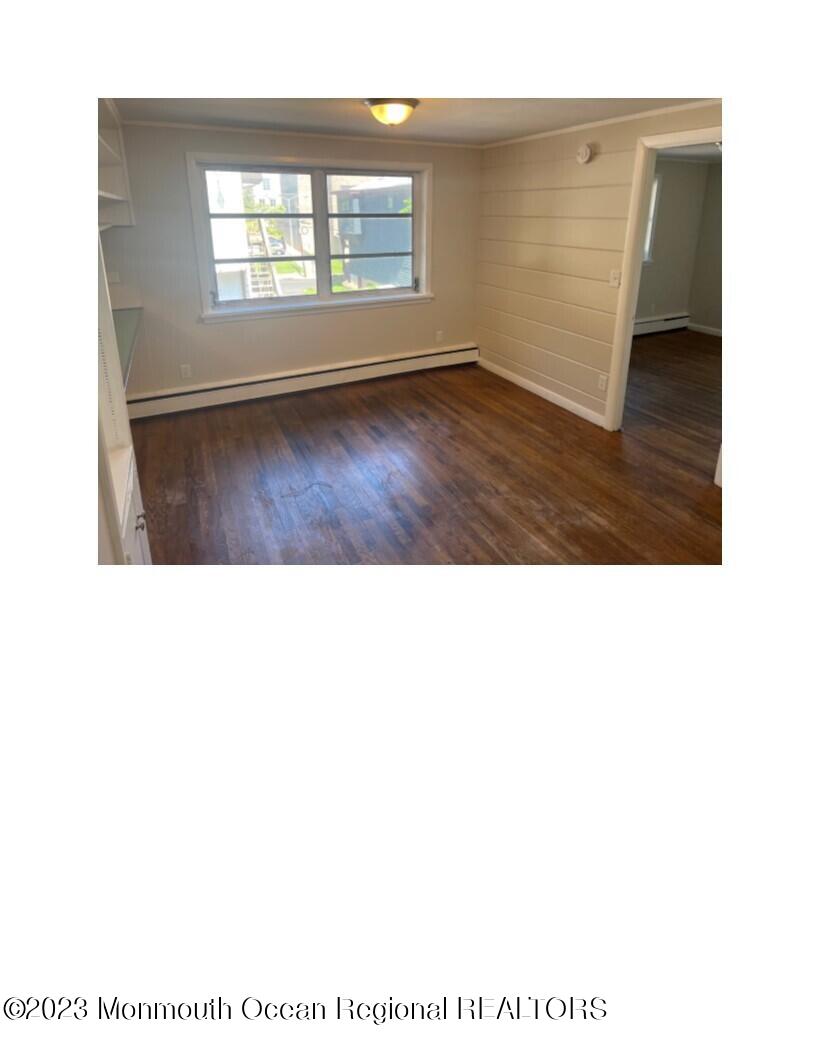 105-107 Atlantic Street Bridgeton, NJ 08302 - Photo 4 of 20 a view of an empty room with wooden floor and a window