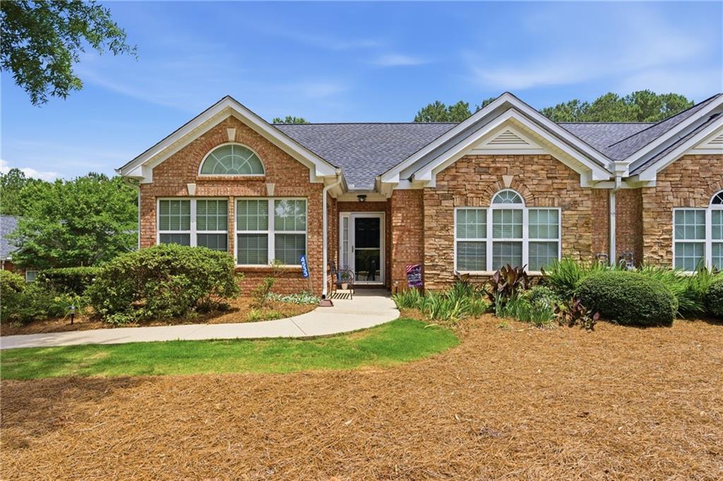4533 Caleb Crossing, Unit 18 Powder Springs, GA 30127 - Photo 2 of 24 a front view of a house with a yard