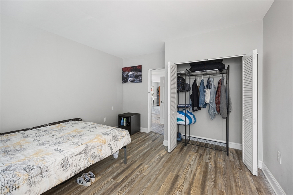 43 Belcourt Road Worcester, MA 01605 - Photo 12 of 26 a bedroom with a bed and a wooden floor