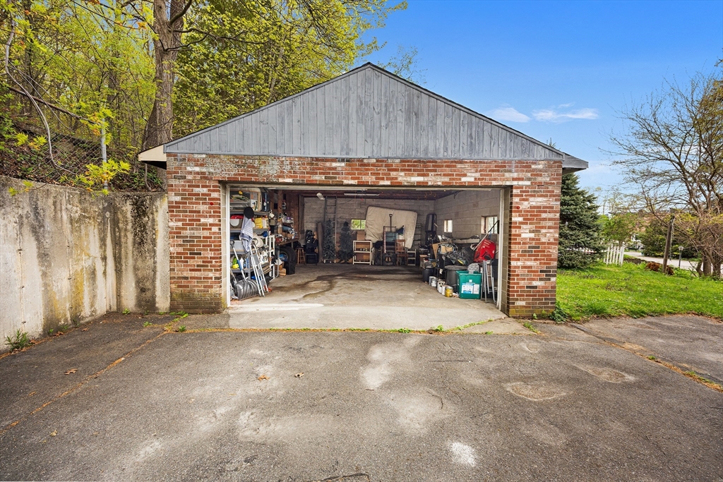 43 Belcourt Road Worcester, MA 01605 - Photo 25 of 26 a view of a house with basket ball court and a garage