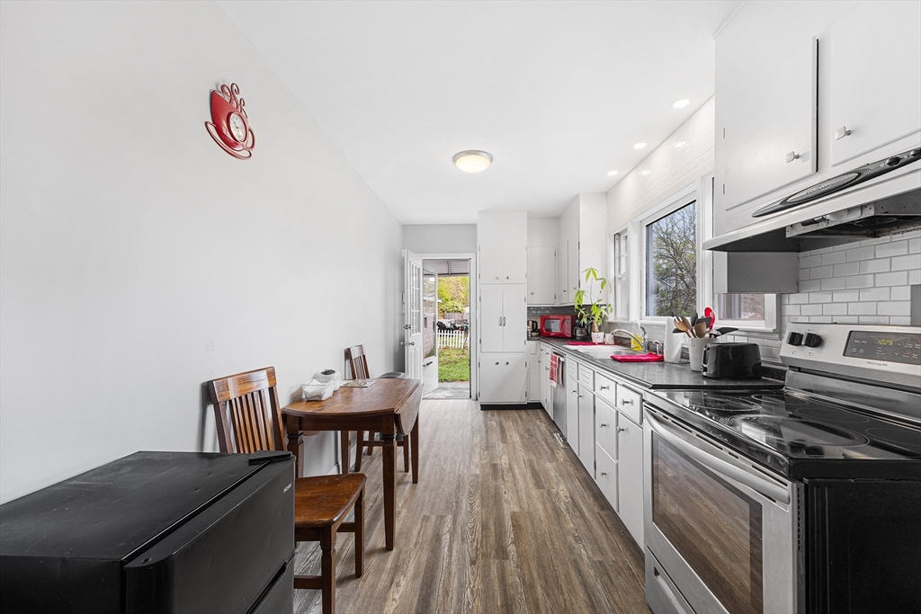 43 Belcourt Road Worcester, MA 01605 - Photo 8 of 26 a kitchen with a table chairs stove and cabinets