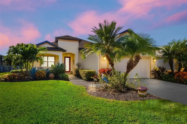 a front view of a house with a garden and a yard