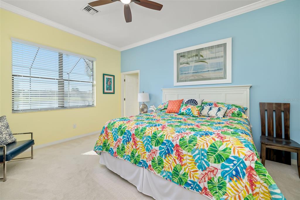 12844 24th St Circle East Parrish, FL 34219 - Photo 17 of 57 a bedroom with a bed and a painting on the wall