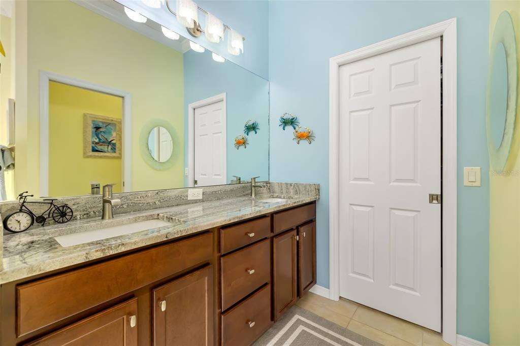 12844 24th St Circle East Parrish, FL 34219 - Photo 20 of 57 a bathroom with a granite countertop sink and a mirror
