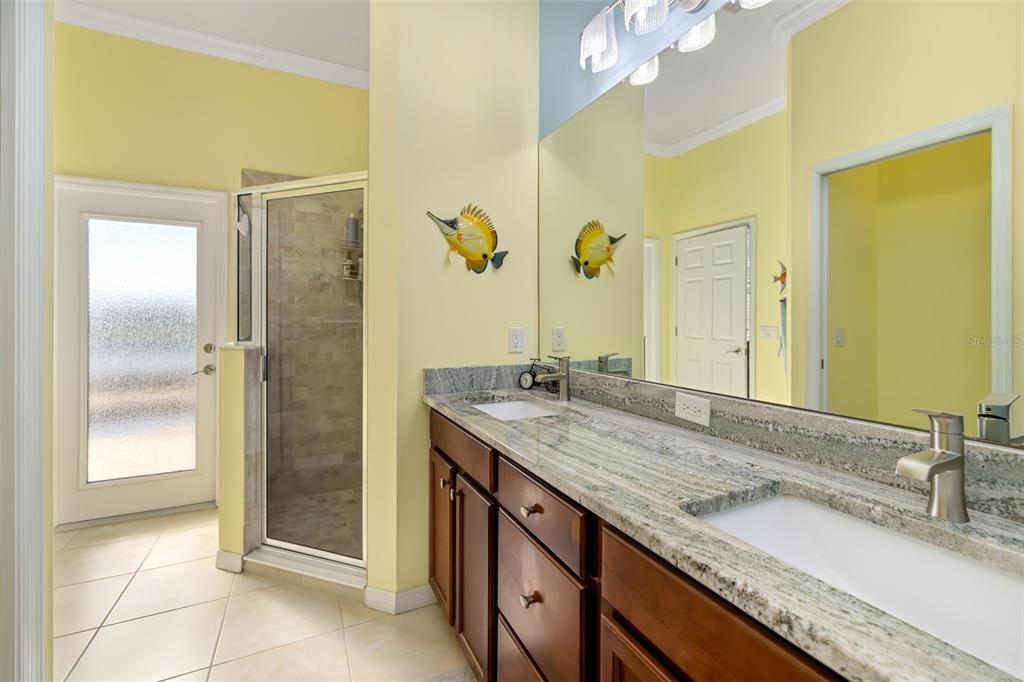 12844 24th St Circle East Parrish, FL 34219 - Photo 22 of 57 a bathroom with a granite countertop sink and a mirror