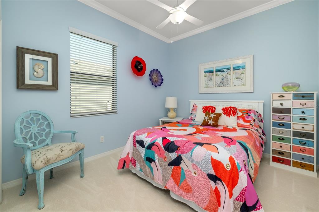 12844 24th St Circle East Parrish, FL 34219 - Photo 28 of 57 a bedroom with a bed and a chandelier