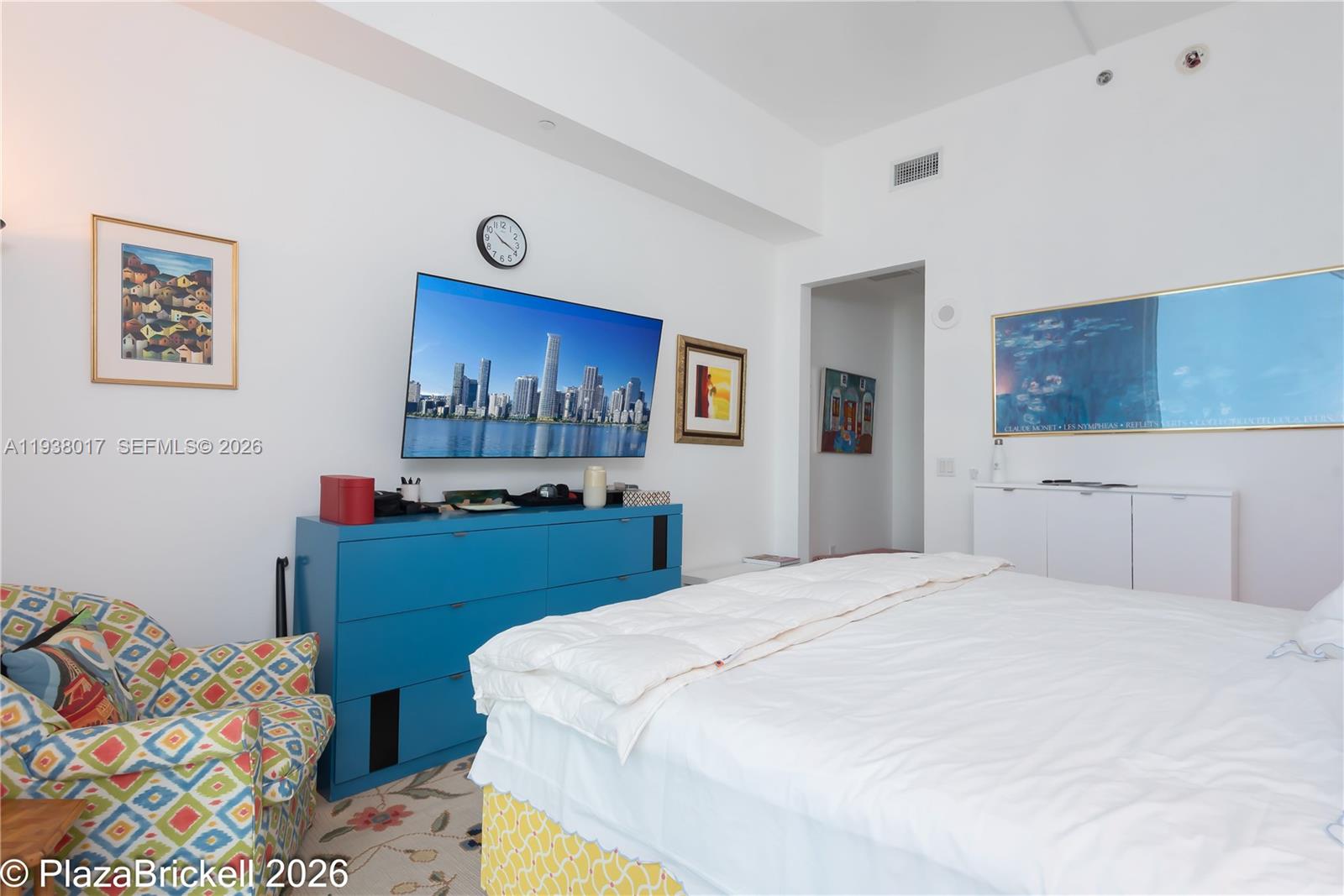 950 Brickell Bay Drive, Unit 5505 Miami, FL 33131 - Photo 17 of 63 a bedroom with a bed and a dresser in it