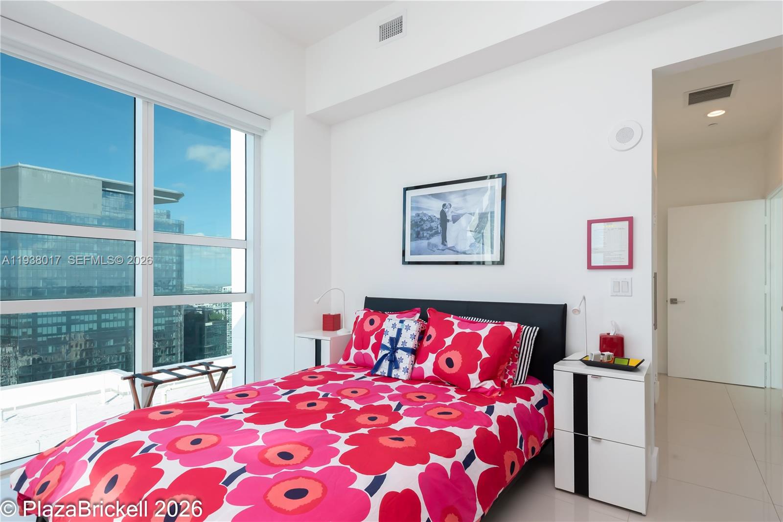 950 Brickell Bay Drive, Unit 5505 Miami, FL 33131 - Photo 22 of 63 a bedroom with a bed and a window