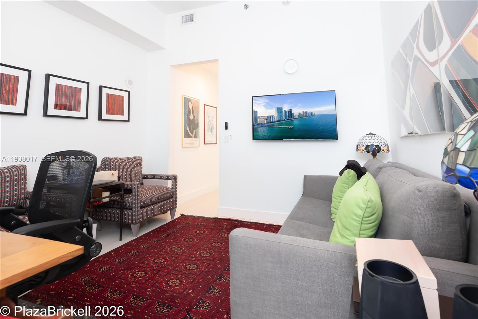 950 Brickell Bay Drive, Unit 5505 Miami, FL 33131 - Photo 26 of 63 a living room with furniture and a flat screen tv