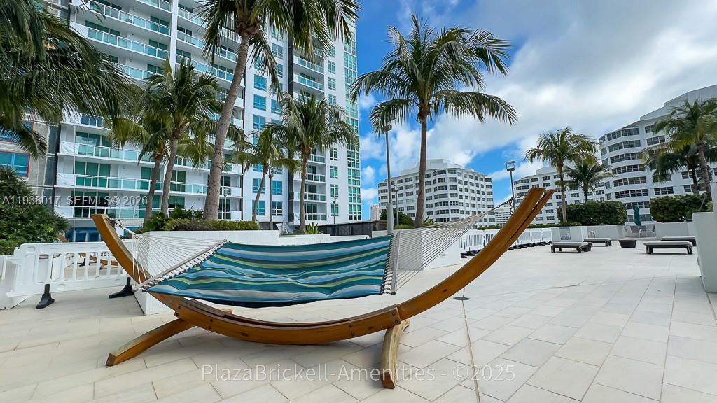 950 Brickell Bay Drive, Unit 5505 Miami, FL 33131 - Photo 41 of 63 a view of swimming pool with a lounge chair and palm trees