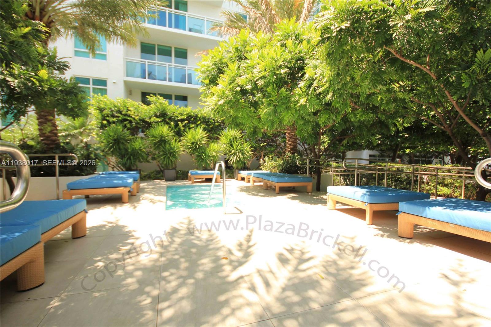950 Brickell Bay Drive, Unit 5505 Miami, FL 33131 - Photo 48 of 63 a view of a swimming pool with a lounge chair