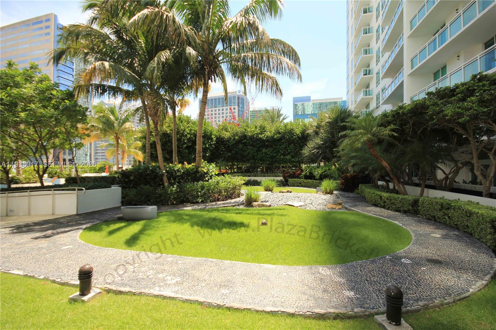 950 Brickell Bay Drive, Unit 5505 Miami, FL 33131 - Photo 50 of 63 a view of a swimming pool with a garden