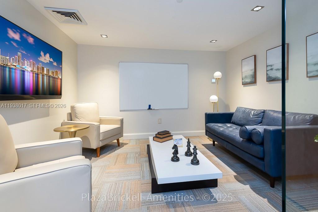 950 Brickell Bay Drive, Unit 5505 Miami, FL 33131 - Photo 56 of 63 a living room with furniture couches and a flat screen tv