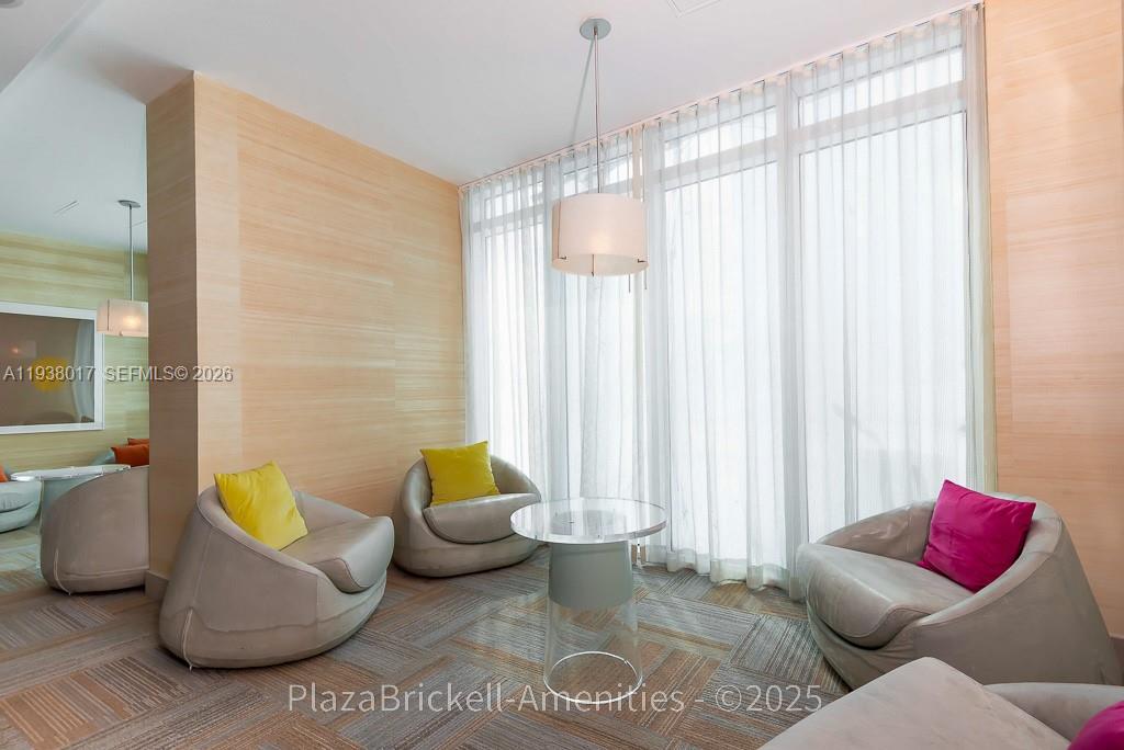 950 Brickell Bay Drive, Unit 5505 Miami, FL 33131 - Photo 62 of 63 a living room with furniture and a chandelier