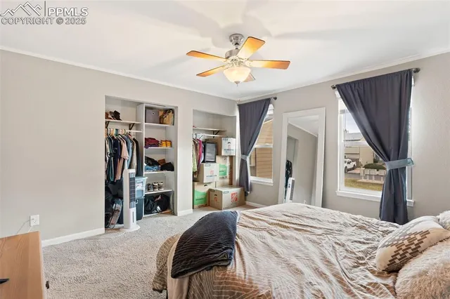 a bedroom with a bed and a flat tv screen on dresser