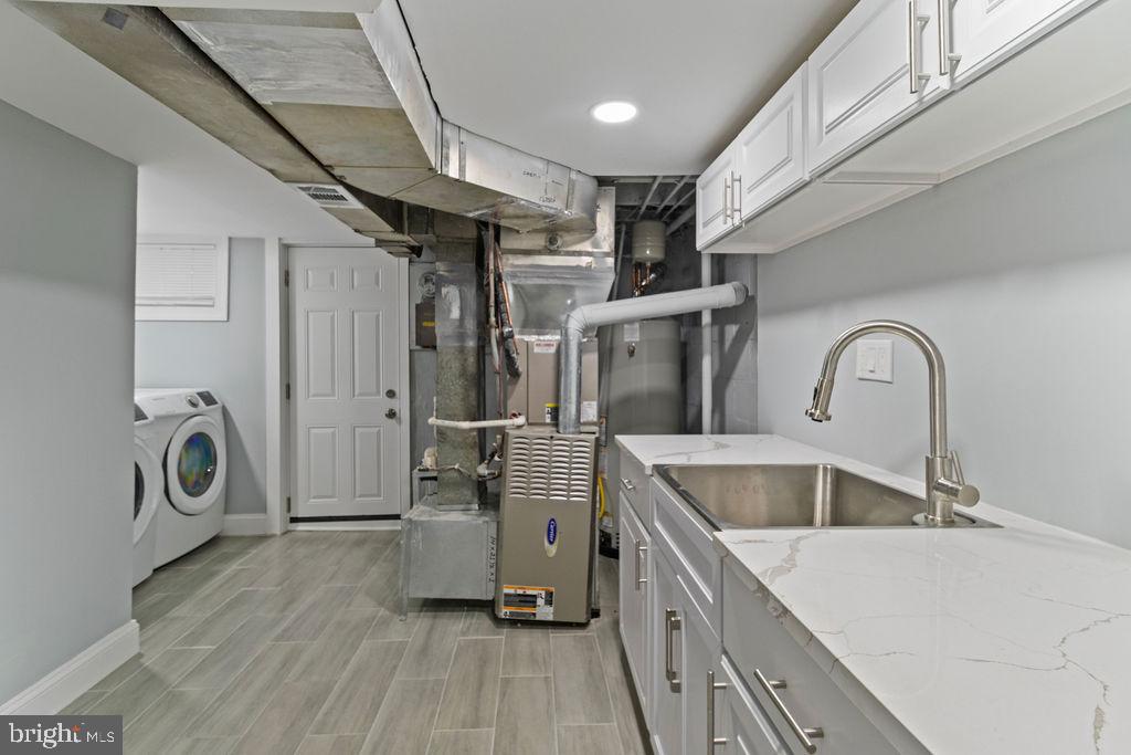 300 Denison Street Baltimore, MD 21229 - Photo 23 of 26 a kitchen with a refrigerator and a sink