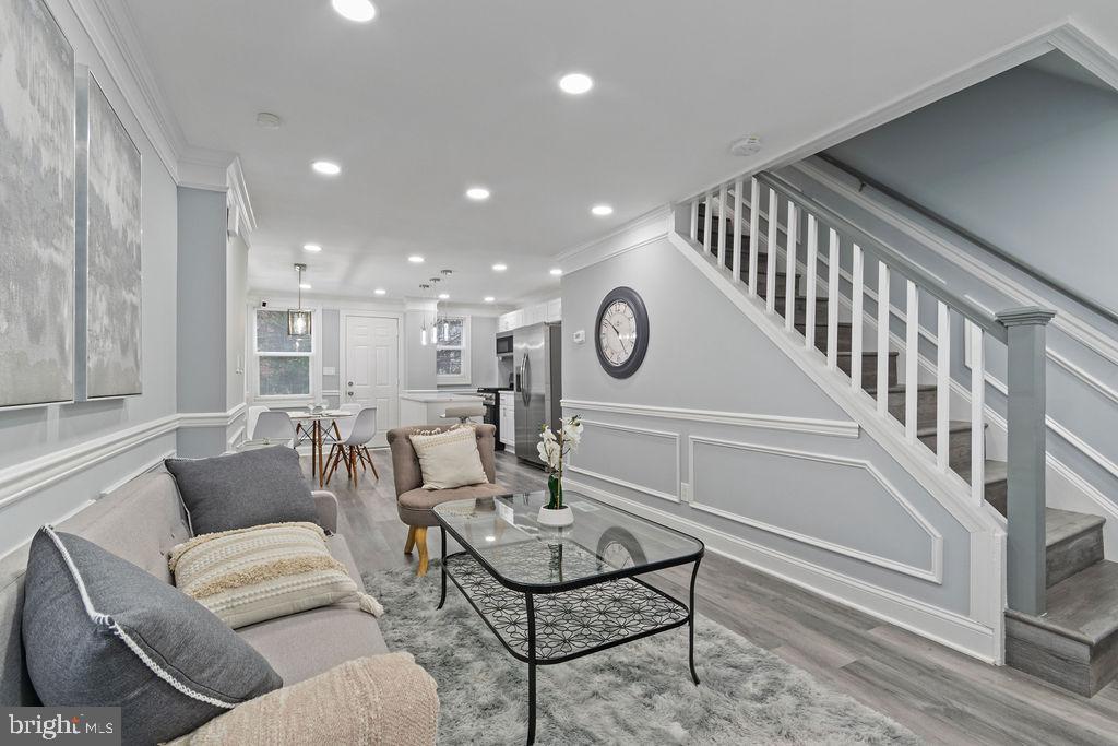 300 Denison Street Baltimore, MD 21229 - Photo 6 of 26 a living room with furniture and a clock