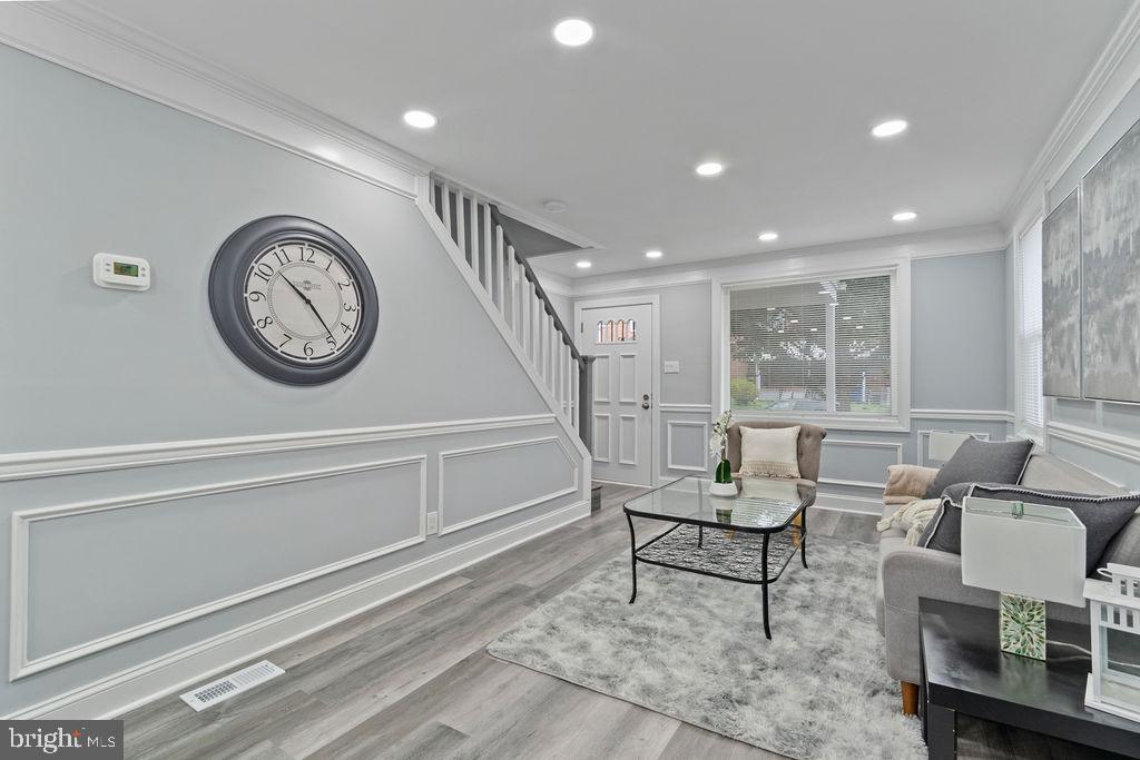 300 Denison Street Baltimore, MD 21229 - Photo 8 of 26 a living room with furniture and a clock