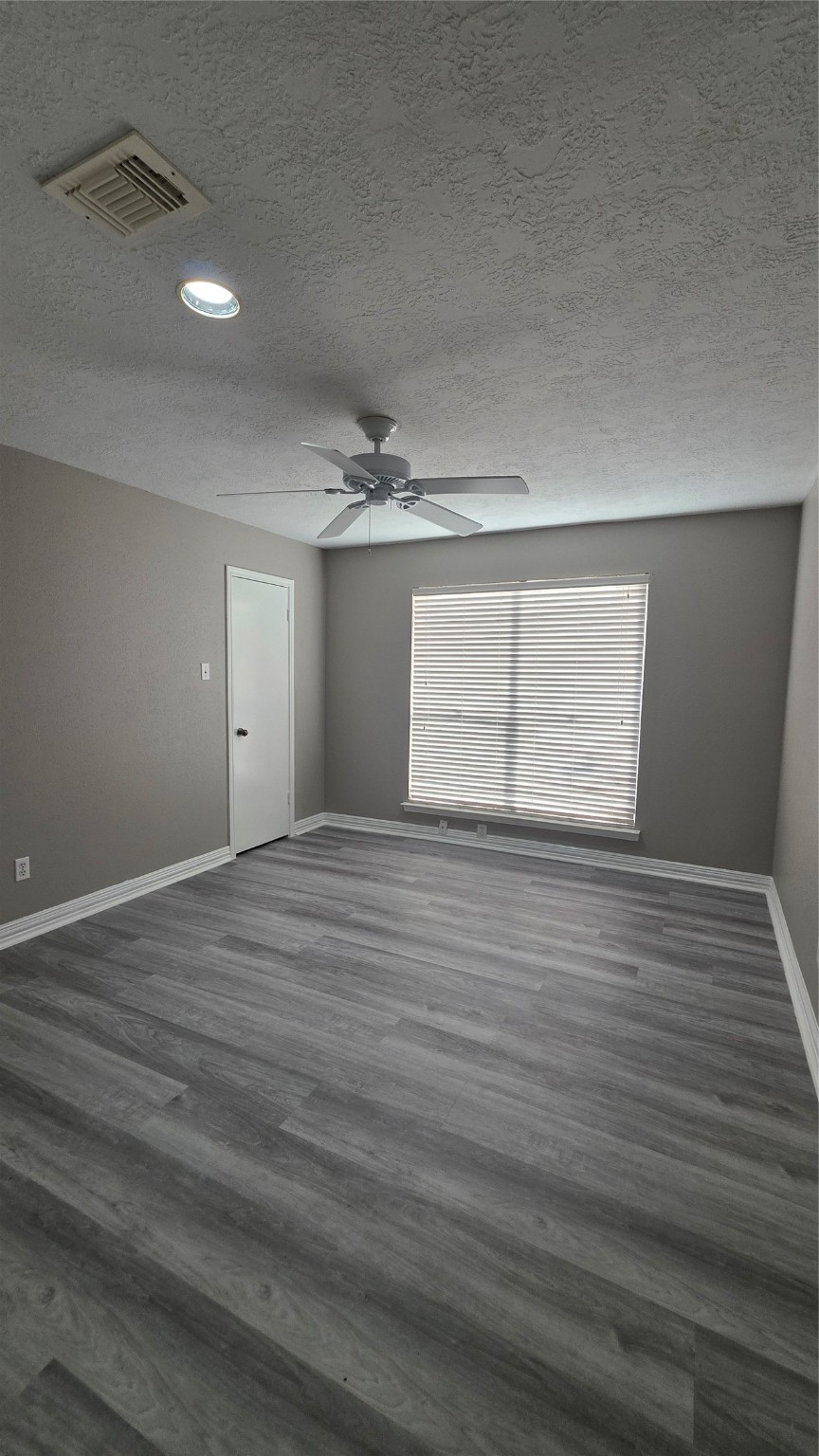 16403 Salinas Lane Houston, TX 77095 - Photo 15 of 17 an empty room with wooden floor and windows