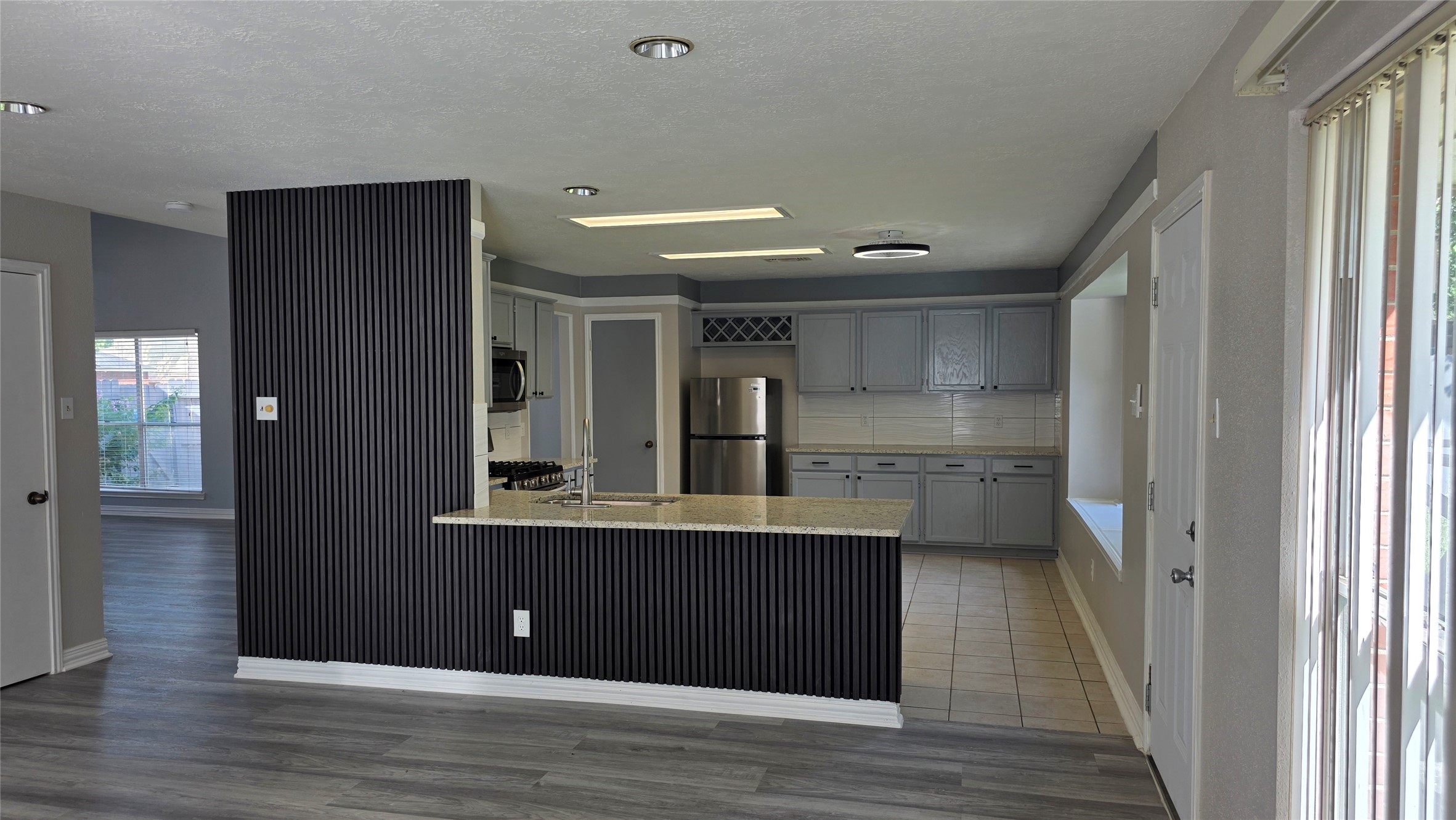 16403 Salinas Lane Houston, TX 77095 - Photo 6 of 17 a view of empty room with wooden floor and cabinet