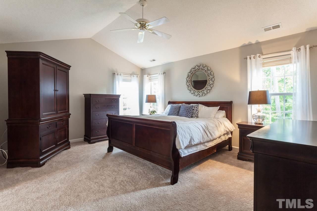 8523 Guerro Court Raleigh, NC 27613 - Photo 15 of 25 Enormous master suites boasts large bedroom with vaulted ceilings, step down into huge master bath and walk in closet.