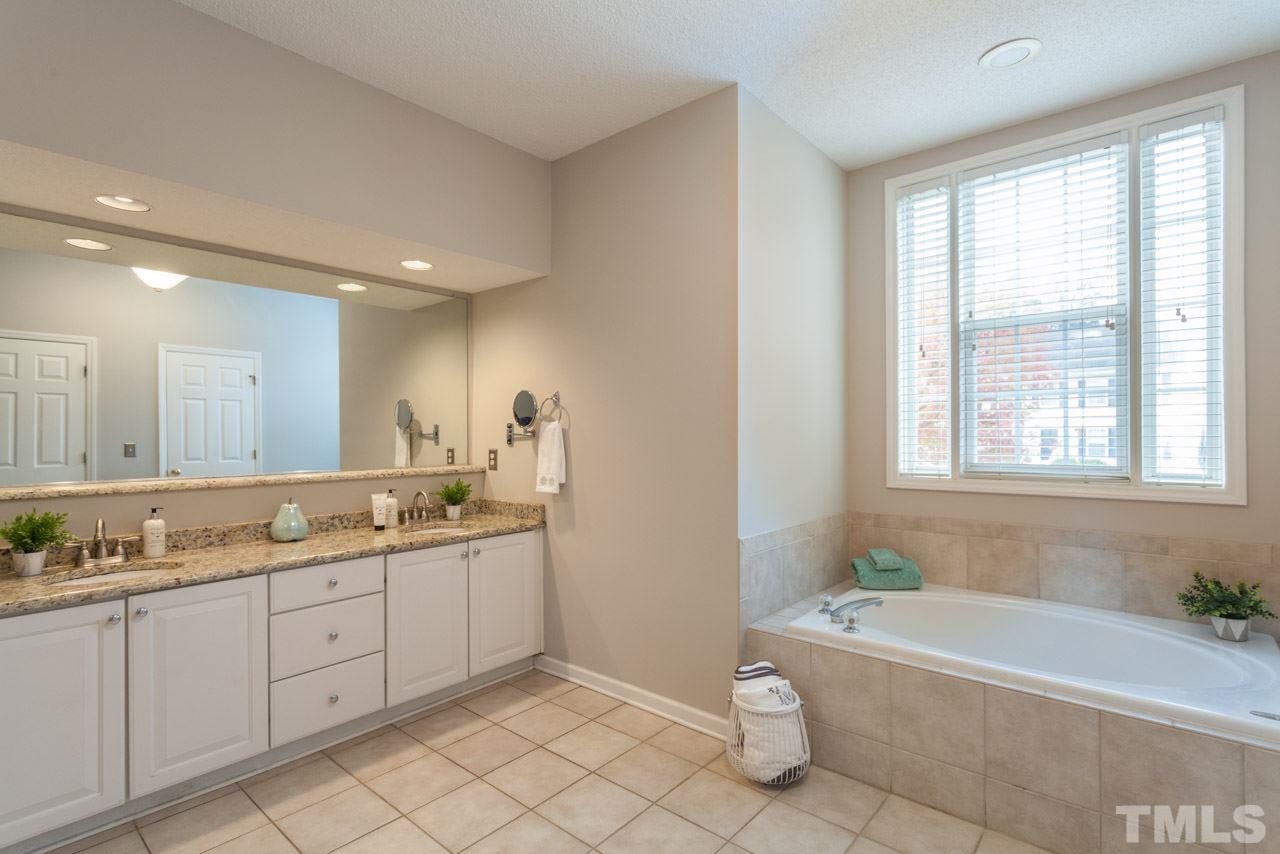 8523 Guerro Court Raleigh, NC 27613 - Photo 16 of 25 Step down into luxurious master bath with soaking tub, walk in shower, dual sinks and plenty of storage!