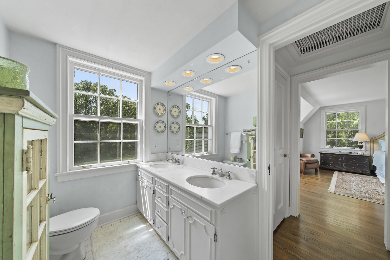 33W627 Army Trail Road Wayne, IL 60184 - Photo 22 of 31 a bathroom with a sink and a large mirror next to a window