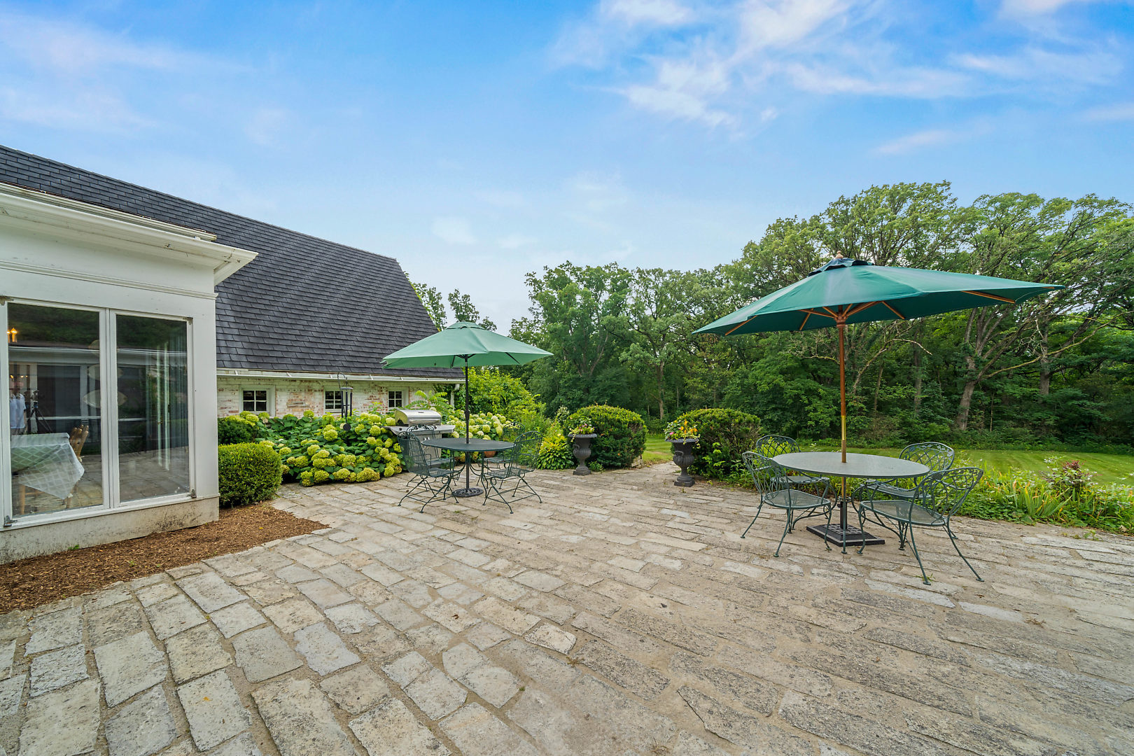 33W627 Army Trail Road Wayne, IL 60184 - Photo 29 of 31 a view of a chair and table with umbrella in front of house