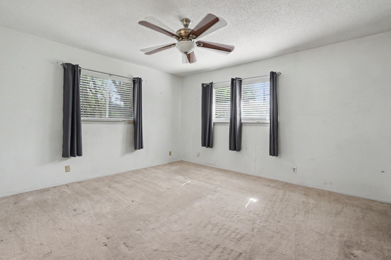 1811 Terry Lane Georgetown, TX 78628 - Photo 16 of 40 A comfortable bedroom featuring carpeted flooring, ample natural illumination, and a modern ceiling fan.