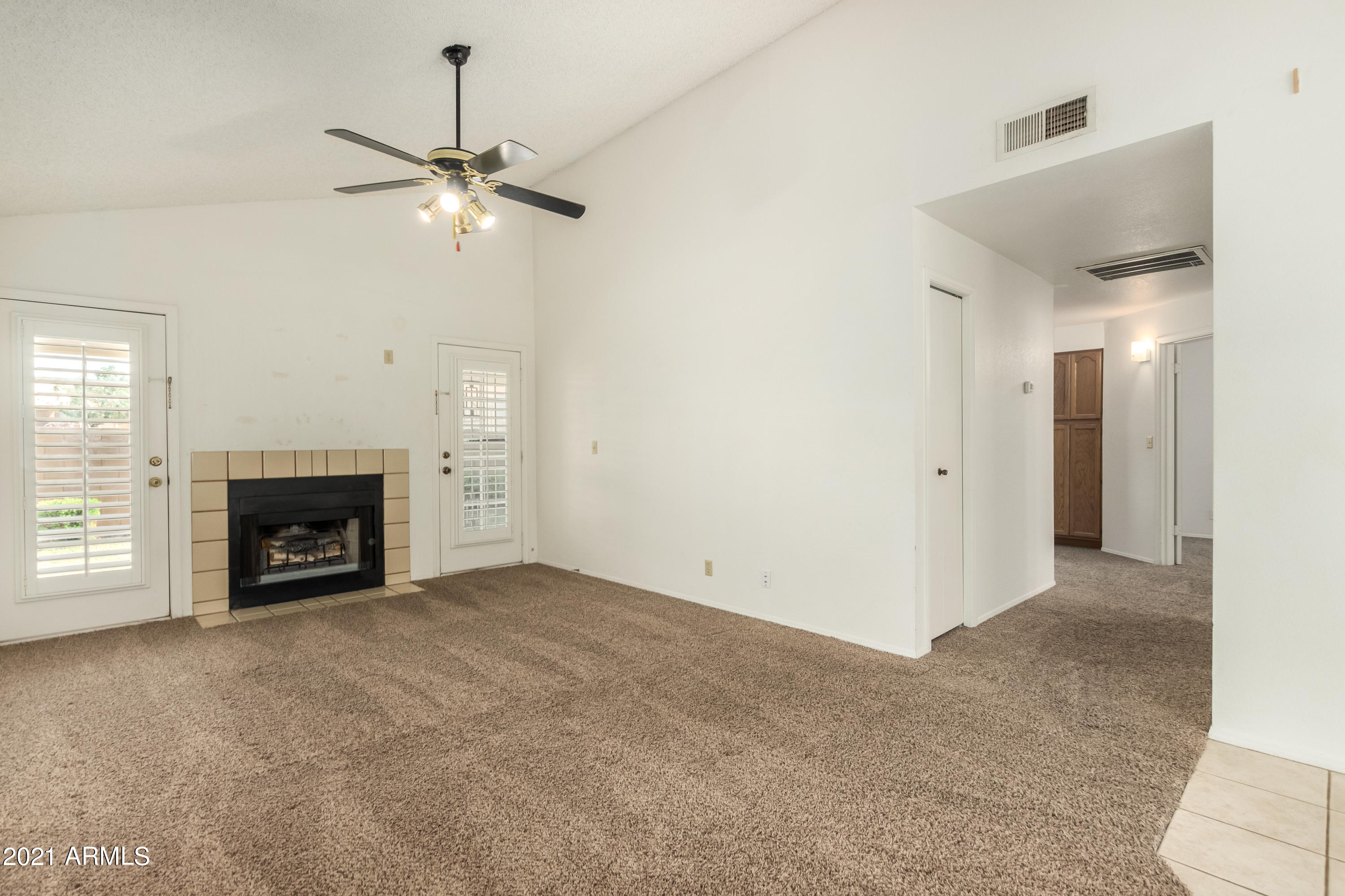 3423 North Apache Circle Chandler, AZ 85224 - Photo 3 of 22 an empty room with windows and fireplace
