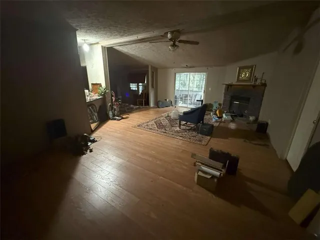 a living room with furniture a fireplace and a floor to ceiling window
