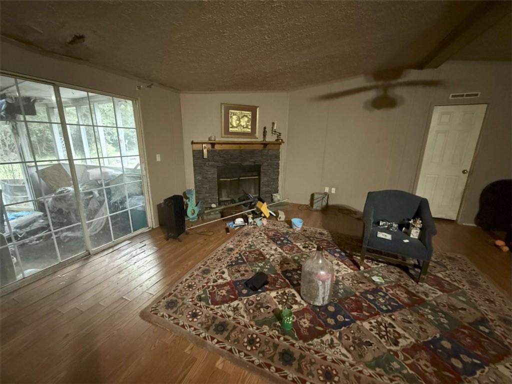 305 Zellner Road Culloden, GA 31016 - Photo 19 of 20 a living room with furniture a fireplace and a floor to ceiling window