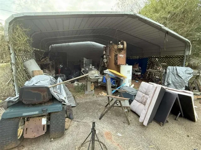 a view of backyard with outdoor seating and barbeque oven