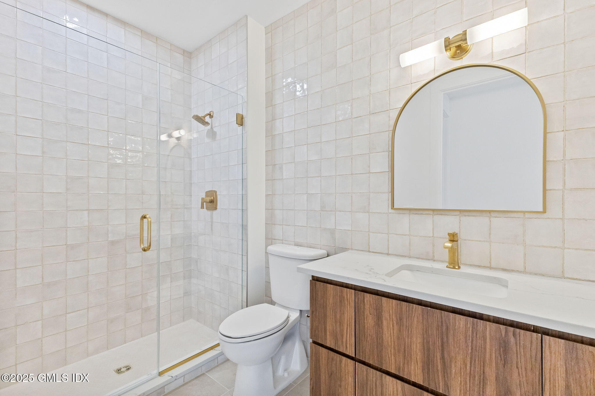 100 East Putnam Avenue, Unit 304 Cos Cob, CT 06807 - Photo 14 of 22 a bathroom with a sink a toilet and shower