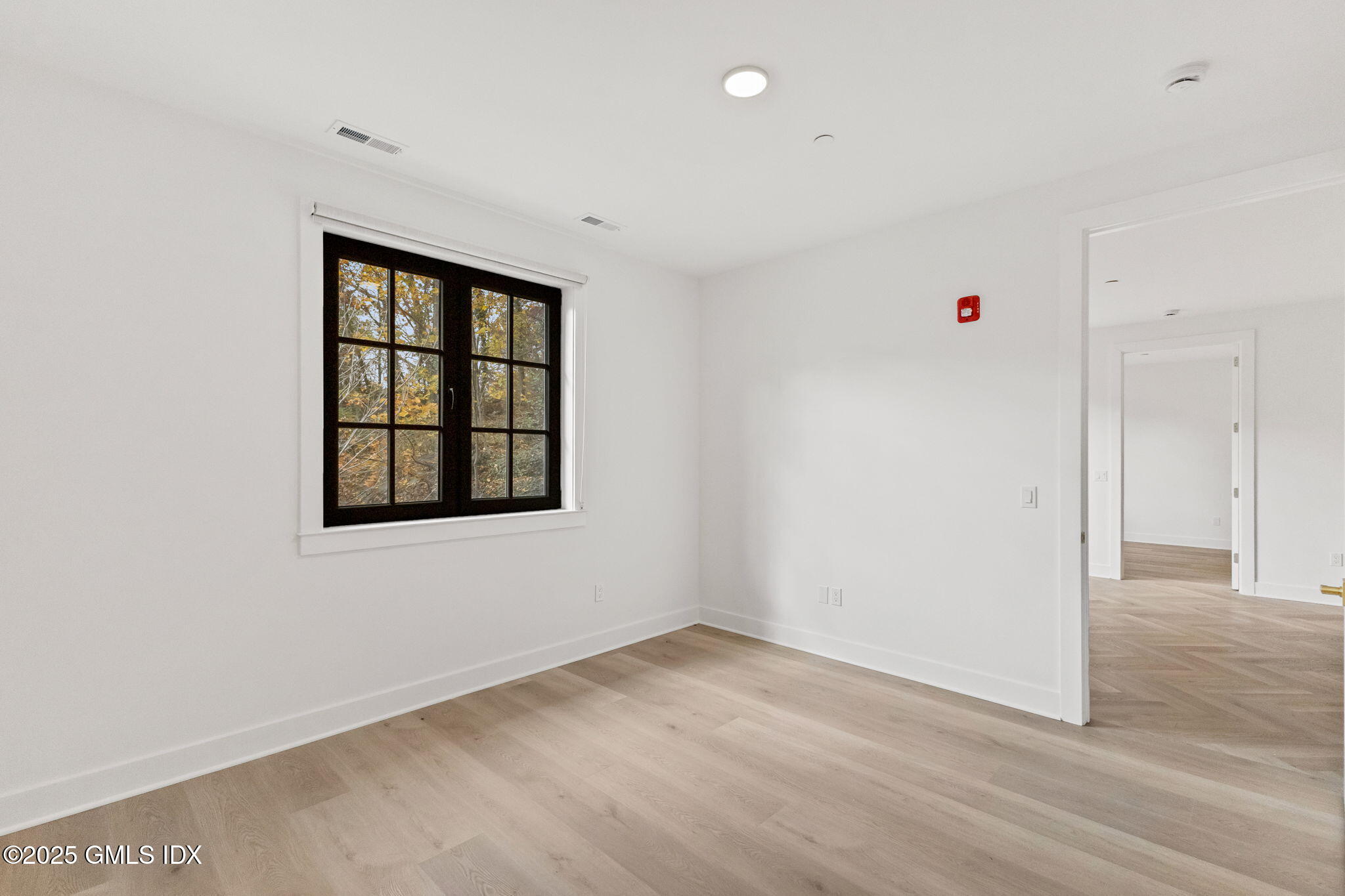 100 East Putnam Avenue, Unit 304 Cos Cob, CT 06807 - Photo 7 of 22 an empty room with wooden floor and windows