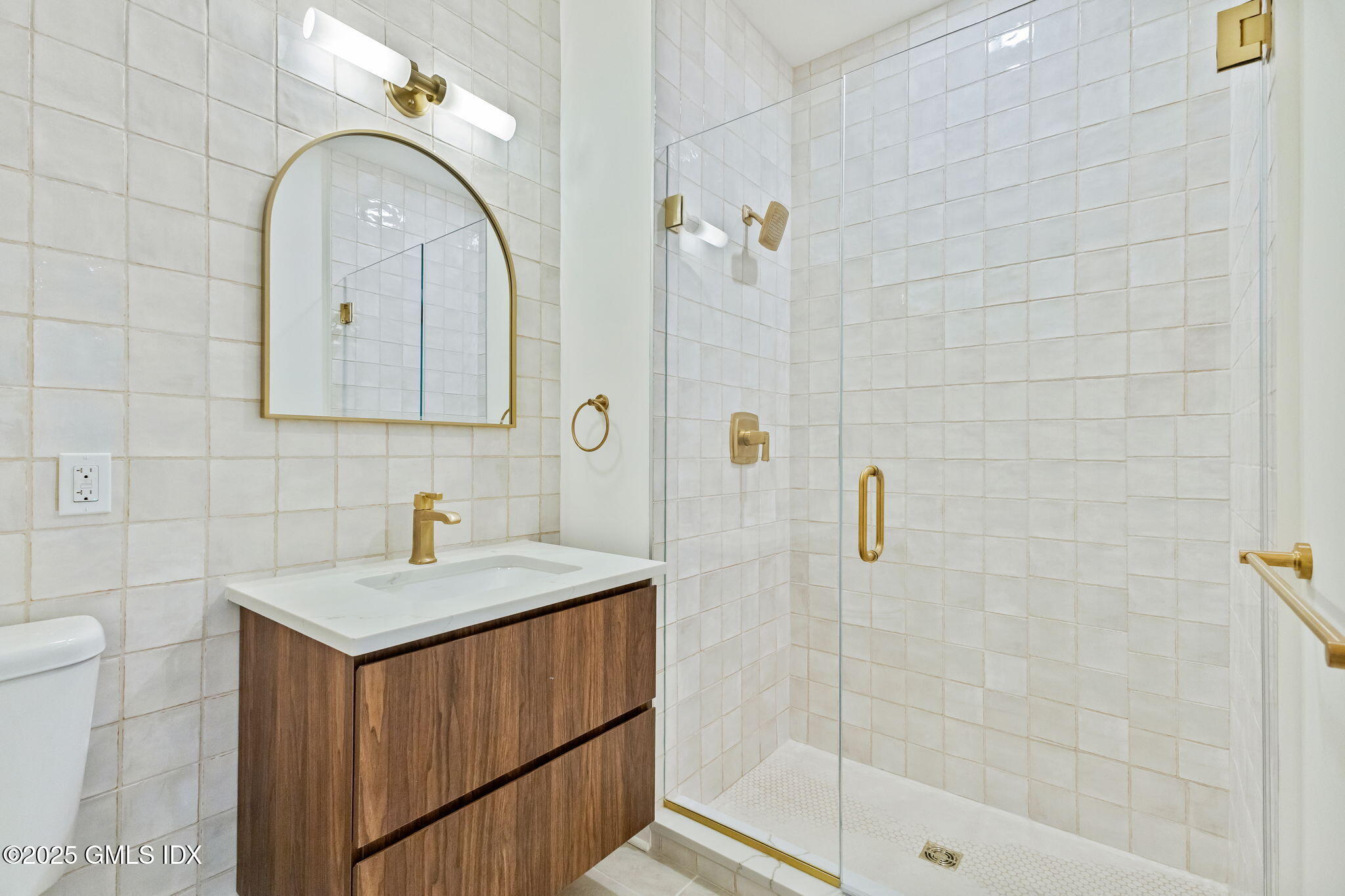 100 East Putnam Avenue, Unit 304 Cos Cob, CT 06807 - Photo 9 of 22 a bathroom with a sink a toilet and shower
