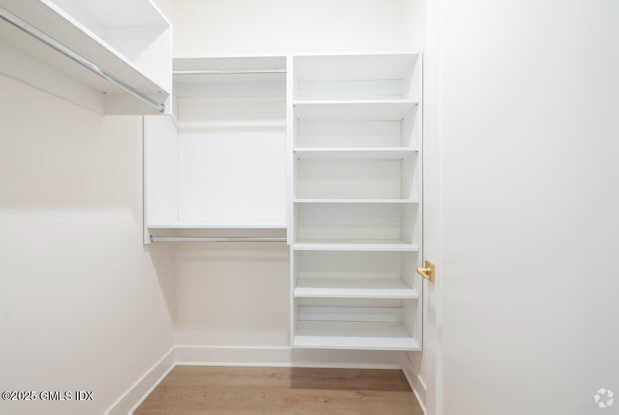 100 East Putnam Avenue, Unit 304 Cos Cob, CT 06807 - Photo 10 of 22 a view of walk in closet with empty racks