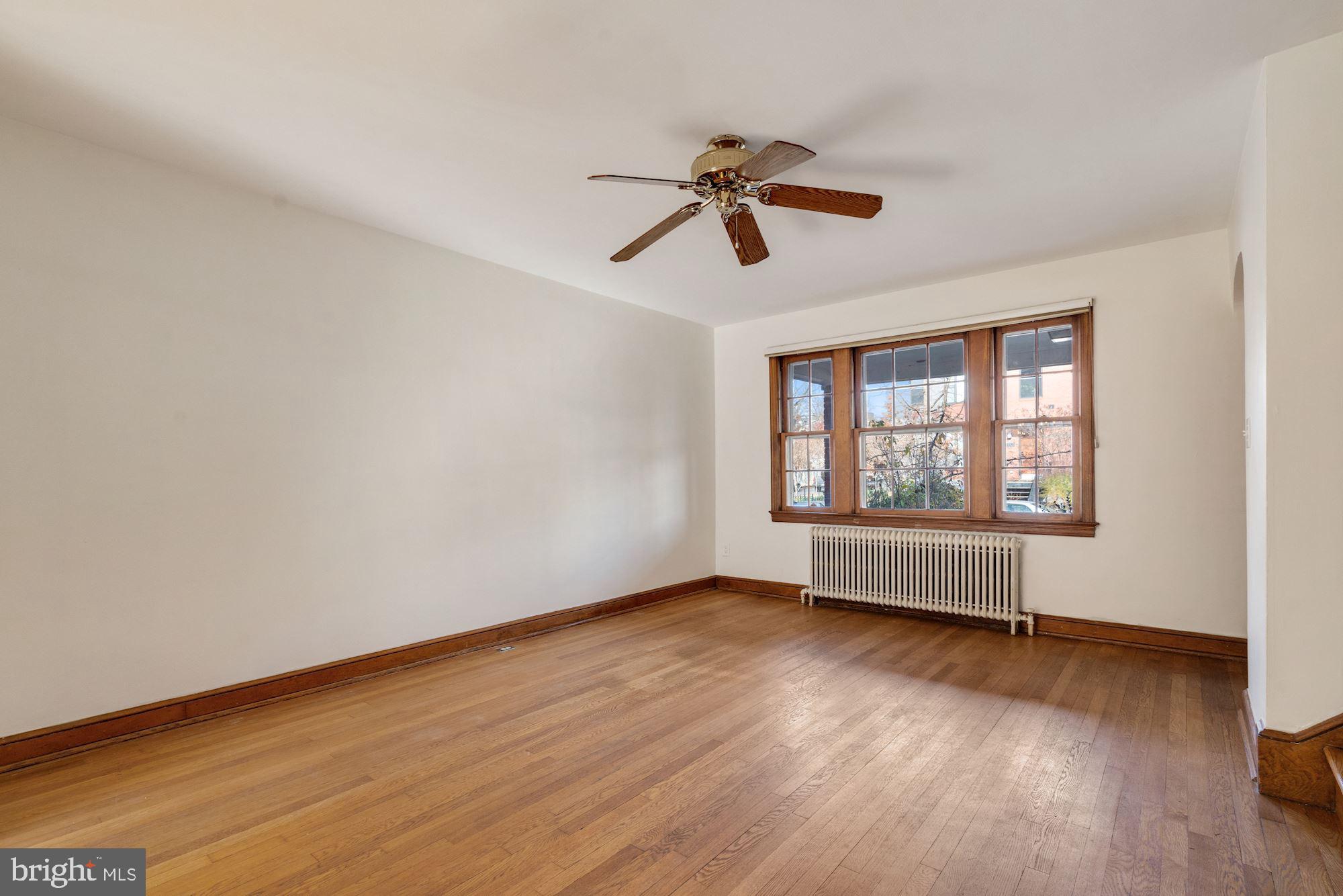 1403 K Street Southeast Washington, DC 20003 - Photo 18 of 74 a view of an empty room with wooden floor and a window