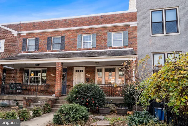 a front view of a house with garden and porch