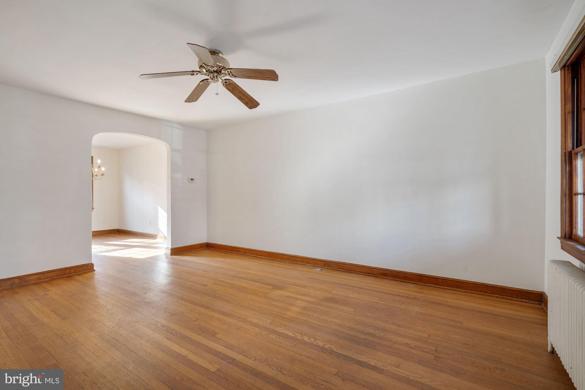 1403 K Street Southeast Washington, DC 20003 - Photo 25 of 74 a view of an empty room with wooden floor and a ceiling fan