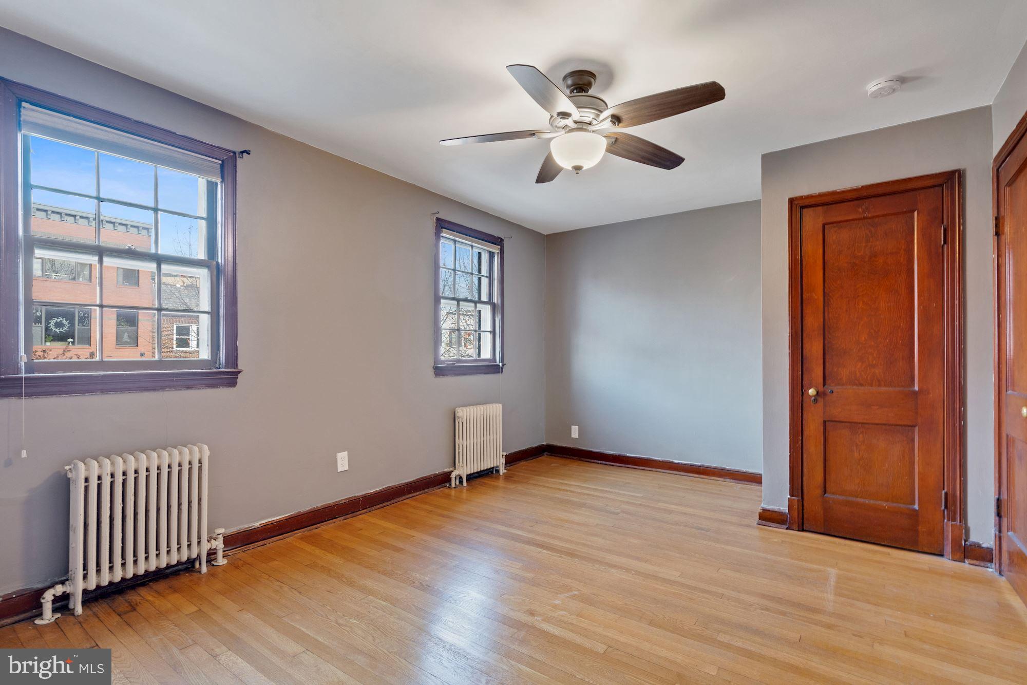 1403 K Street Southeast Washington, DC 20003 - Photo 28 of 74 an empty room with wooden floor fan and windows