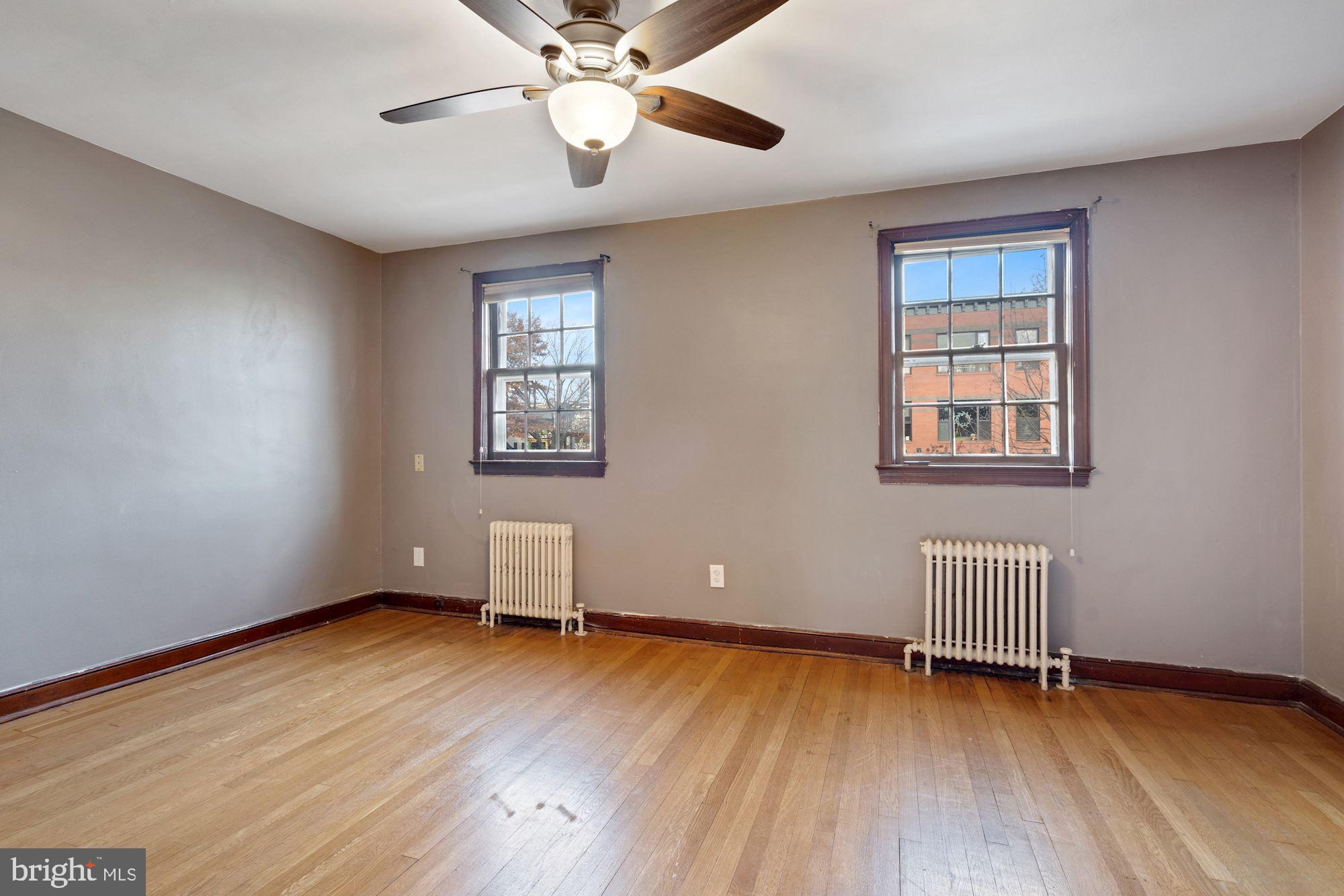 1403 K Street Southeast Washington, DC 20003 - Photo 29 of 74 a view of an empty room with a window and wooden floor